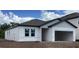 New construction home featuring a garage, double windows, and light gray siding at 2373 Broadbrook Drive, St Cloud, FL 34771