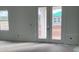Unfinished living room with lots of natural light through doors and window at 2373 Broadbrook Drive, St Cloud, FL 34771