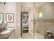 Spa-like bathroom with a glass-enclosed shower, tiled walls, and a glimpse into the relaxing bedroom at 852 Arbor Green Trl, St Cloud, FL 34771