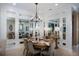 Elegant dining room with a round table, comfortable chairs, and mirrored walls that enhance the sense of space at 852 Arbor Green Trl, St Cloud, FL 34771