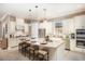 Well-equipped kitchen with white cabinets, a large center island, and modern stainless steel appliances at 852 Arbor Green Trl, St Cloud, FL 34771