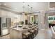 Stylish kitchen featuring a large island with seating, sleek stainless steel appliances, and pendant lighting at 852 Arbor Green Trl, St Cloud, FL 34771