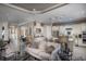 Open-concept living space with a cozy sofa, a view of the kitchen, and elegant lighting fixtures at 852 Arbor Green Trl, St Cloud, FL 34771