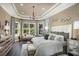Bright main bedroom featuring hardwood floors, bay window and tray ceiling with crown molding at 852 Arbor Green Trl, St Cloud, FL 34771