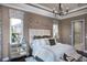Bright and airy main bedroom showing decorative headboard, lamps, and mirrored bedside tables at 852 Arbor Green Trl, St Cloud, FL 34771