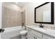 Bathroom featuring a tub/shower combo, gray tile, granite counters, and modern fixtures at 7728 Somersworth Dr, Kissimmee, FL 34747