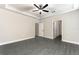 Large main bedroom featuring trey ceilings, crown molding, gray floors and multiple doorways at 7728 Somersworth Dr, Kissimmee, FL 34747