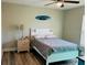 Bright bedroom featuring a comfortable bed and wood floors at 9320 Se 163Rd St, Summerfield, FL 34491