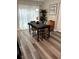 Spacious dining area with wood-look flooring and a modern table set at 9320 Se 163Rd St, Summerfield, FL 34491