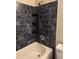 Updated bathroom with dark blue tile and built-in shelving at 422 22Nd Sw St, Winter Haven, FL 33880