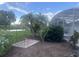 A charming backyard with tropical trees, landscaping and screened pool enclosure at 2514 Sage Dr, Kissimmee, FL 34758