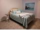 Comfortable bedroom featuring a bed with decorative pillows, a quilt, and a charming side table at 2514 Sage Dr, Kissimmee, FL 34758