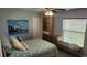 Relaxing bedroom features a bed, window with blinds, a seating nook, and a decorative painting at 2514 Sage Dr, Kissimmee, FL 34758