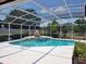 Inviting pool with a spa and covered enclosure surrounded by well-maintained landscaping at 2514 Sage Dr, Kissimmee, FL 34758