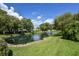 Community pond with fountain and lush greenery at 1226 Charter Oaks Cir, Daytona Beach, FL 32117