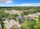 Aerial view featuring a neighborhood with well-kept homes, mature trees, and lush greenery at 319 Ravenshill Way, Deland, FL 32724
