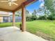 Covered patio overlooking a large, well-manicured backyard, ideal for relaxation and outdoor activities at 319 Ravenshill Way, Deland, FL 32724