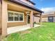 Charming covered patio with ceiling fan, perfect for outdoor dining and entertaining with backyard views at 319 Ravenshill Way, Deland, FL 32724