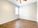 Well-lit bedroom with hardwood flooring and ceiling fan at 319 Ravenshill Way, Deland, FL 32724
