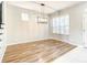 Dining room with wood floors, light gray walls, black metal chandelier and natural light at 319 Ravenshill Way, Deland, FL 32724