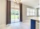 Light and bright dining area with backyard access and a modern chandelier at 319 Ravenshill Way, Deland, FL 32724