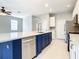 The kitchen has a blue island with a white countertop and stainless steel appliances at 319 Ravenshill Way, Deland, FL 32724