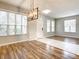 Living room boasts hardwood floors, light gray walls, and lots of natural light at 319 Ravenshill Way, Deland, FL 32724