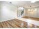 Spacious living room featuring wood floors, natural light, and stairway to the upper level at 319 Ravenshill Way, Deland, FL 32724