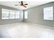 Spacious living room with tile flooring, ceiling fan and multiple windows at 319 Ravenshill Way, Deland, FL 32724