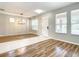 This large, light filled living room features an elegant light fixture and lots of windows at 319 Ravenshill Way, Deland, FL 32724