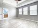 Bright main bedroom offers tray ceilings, three large windows, and en-suite bathroom at 319 Ravenshill Way, Deland, FL 32724