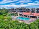 Luxury condo building with pool and lush landscaping at 520 S Peninsula Ave # 2D7, New Smyrna Beach, FL 32169