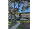 Two-story condo building with parking and landscaped grounds at 520 S Peninsula Ave # 2D7, New Smyrna Beach, FL 32169