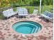 Community hot tub with surrounding patio furniture at 520 S Peninsula Ave # 2D7, New Smyrna Beach, FL 32169