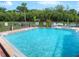 Community swimming pool with a surrounding patio and hot tub at 520 S Peninsula Ave # 2D7, New Smyrna Beach, FL 32169