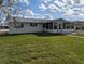 Well-kept backyard with a screened-in porch and a cozy seating area, perfect for outdoor relaxation at 1628 Paradise Ln, Astor, FL 32102