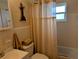 Bathroom with a shower/tub, toilet, vanity, and nautical-themed decorations at 1628 Paradise Ln, Astor, FL 32102