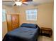 Bedroom featuring neutral tones and furnishings, including a bed, cabinet, and side table at 1628 Paradise Ln, Astor, FL 32102