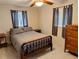 Cozy bedroom features a comfortable bed, ceiling fan, and natural light at 1628 Paradise Ln, Astor, FL 32102