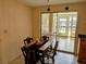 Eat in dining room with wooden table and chairs, adjacent to the kitchen and sunroom at 1628 Paradise Ln, Astor, FL 32102