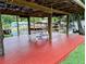 Waterfront home features a large covered dock with a picnic table for enjoying meals by the water at 1628 Paradise Ln, Astor, FL 32102