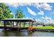 Waterfront home featuring a private covered boat dock with a lift for easy water access at 1628 Paradise Ln, Astor, FL 32102