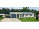 Charming single-story home with a well-manicured lawn, neutral paint, and a convenient carport at 1628 Paradise Ln, Astor, FL 32102