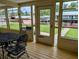 Enclosed patio featuring metal patio furniture with a view of the yard and waterway at 1628 Paradise Ln, Astor, FL 32102