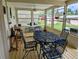 Enclosed patio with metal patio furniture overlooking a spacious, grassy yard at 1628 Paradise Ln, Astor, FL 32102