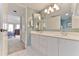 Bright bathroom featuring a double sink vanity and modern lighting fixture at 3 Oceans West Blvd # 5C4, Daytona Beach Shores, FL 32118