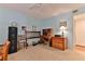 Bedroom with neutral carpet, ceiling fan, light blue walls, and a functional desk setup at 3 Oceans West Blvd # 5C4, Daytona Beach Shores, FL 32118