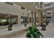 Hallway with view of lounge area with furniture, potted plants, tile flooring and pillars at 3 Oceans West Blvd # 5C4, Daytona Beach Shores, FL 32118
