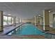 Indoor community pool with lounge chairs on the deck, with grid ceiling and pillars at 3 Oceans West Blvd # 5C4, Daytona Beach Shores, FL 32118