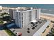 Aerial view of a condo building, offering stunning beach proximity and convenient parking at 1415 Ocean Shore Blvd # 309, Ormond Beach, FL 32176